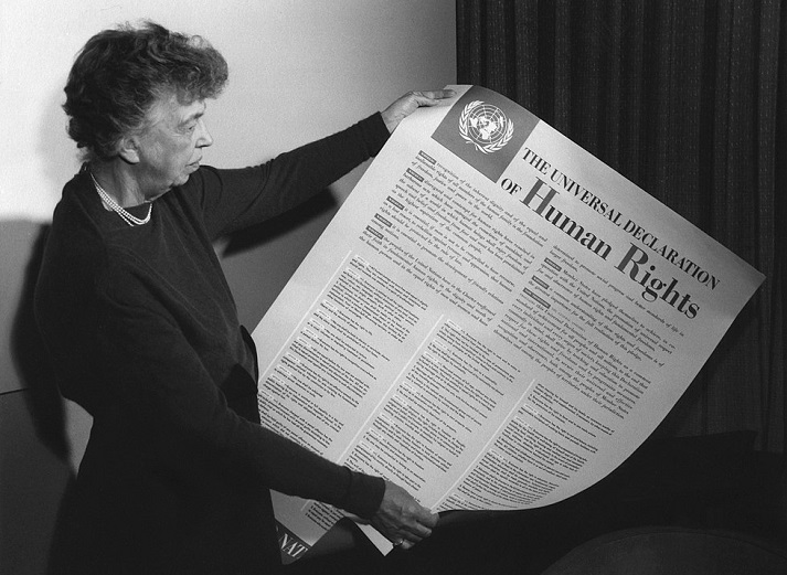Eleanor Roosevelt holding a poster of the Universal Declaration of Human Rights in 1949