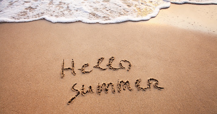 hello, summer written on the beach sand