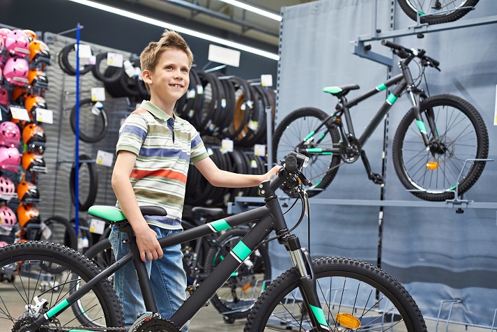 boy buying a bicycle in a bicye shop