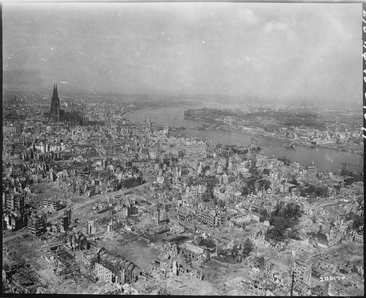 Cologne Cathedral stands undamaged while entire area surrounding it is completely devastated. Railroad station and Hohenzollern Bridge lie damaged to the north and east of the cathedral. Germany, April 24, 1945.
