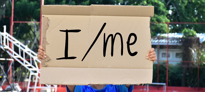 Subject and object pronouns 'I and me' on paper holding in the hands of the student