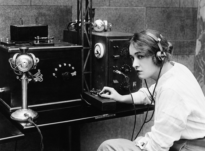 woman sending Morse code using telegraph