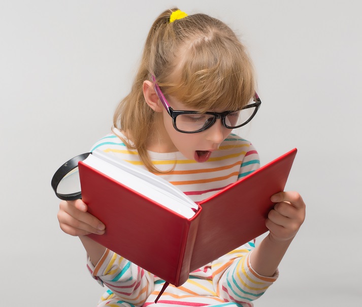 girl with a book and a magnifying glass