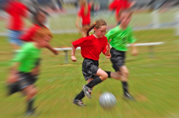 female soccer player running with the ball