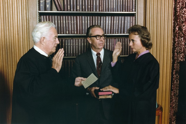 Photograph of Sandra Day O'Connor Being Sworn in a Supreme Court Justice by Chief Justice Warren Burger, Her Husband John O'Connor Looks On, 09/25/1981