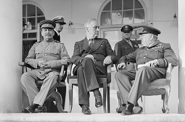 Joseph Stalin, Franklin D. Roosevelt, and Winston Churchill on the veranda of the Soviet Legation in Teheran during the first Big Three Conference, November 1943.