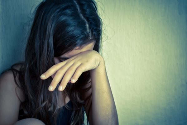 Lonely girl crying with a hand covering her face Online Homeschool
